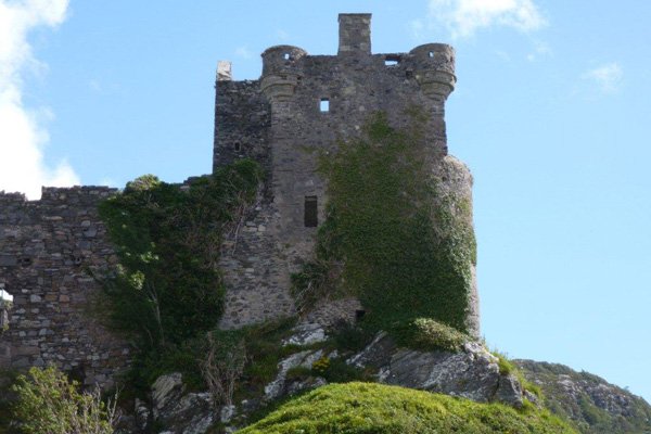 External view of modfied old tower house with apartments and rounded turrets.