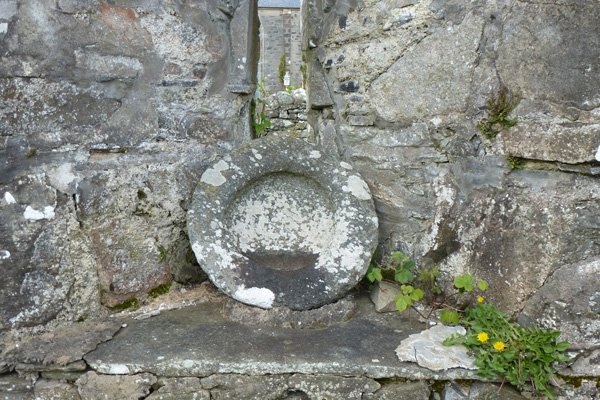 A stone stoup (holy water container)