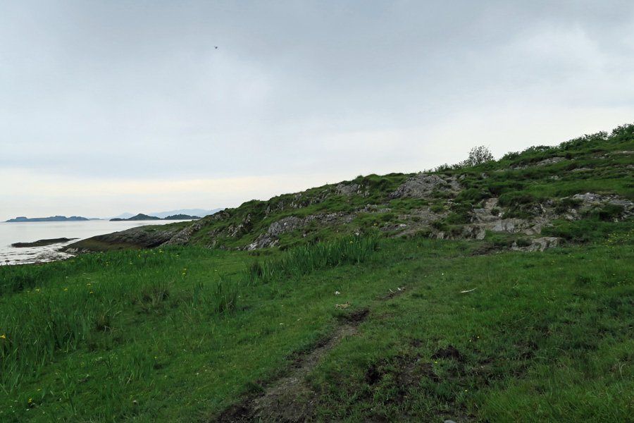 Follow the faint path over the rocky outcrop