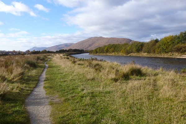 The path across rough meadow by River Lochy