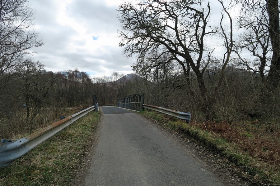 Park by the large metal bridge 
