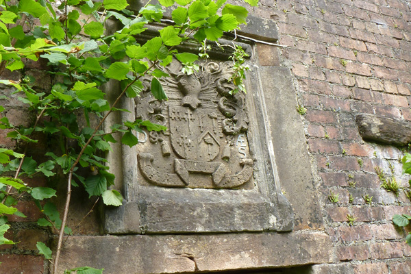 The crest above the door to the unfinished building
